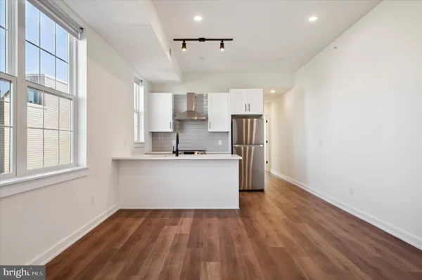 a view of kitchen with stainless steel appliances cabinets