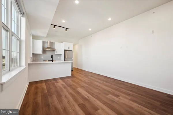 a view of kitchen with wooden floor and window
