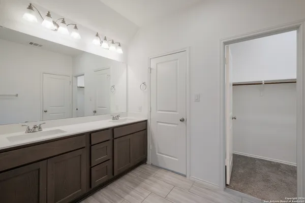 an empty room with chandelier fan