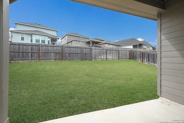 a backyard of a house with table and chairs