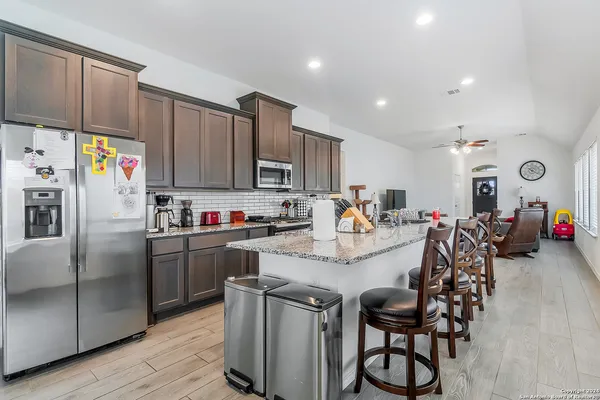 a kitchen with refrigerator and cabinets