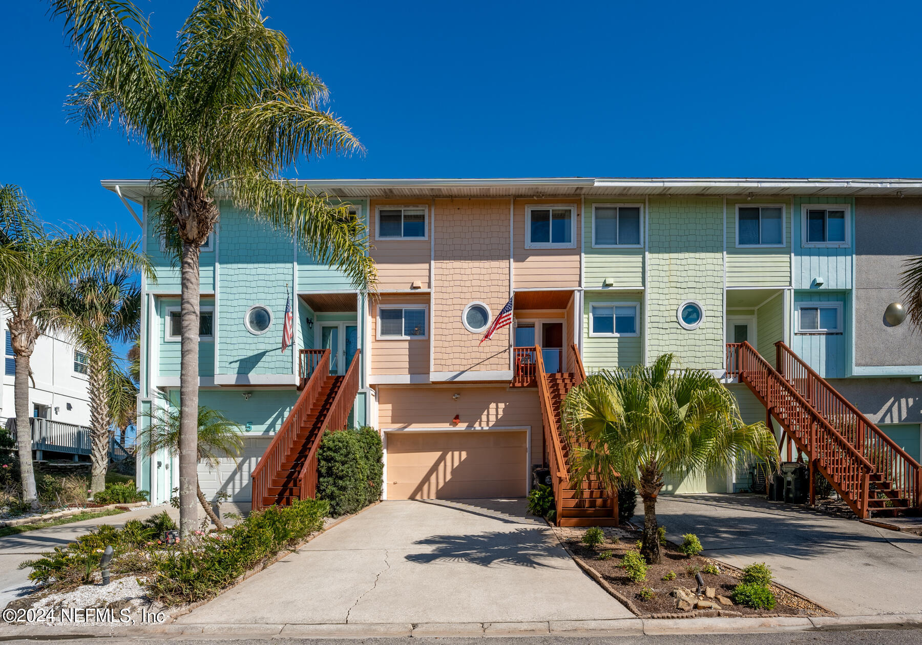 a front view of a house with a tree