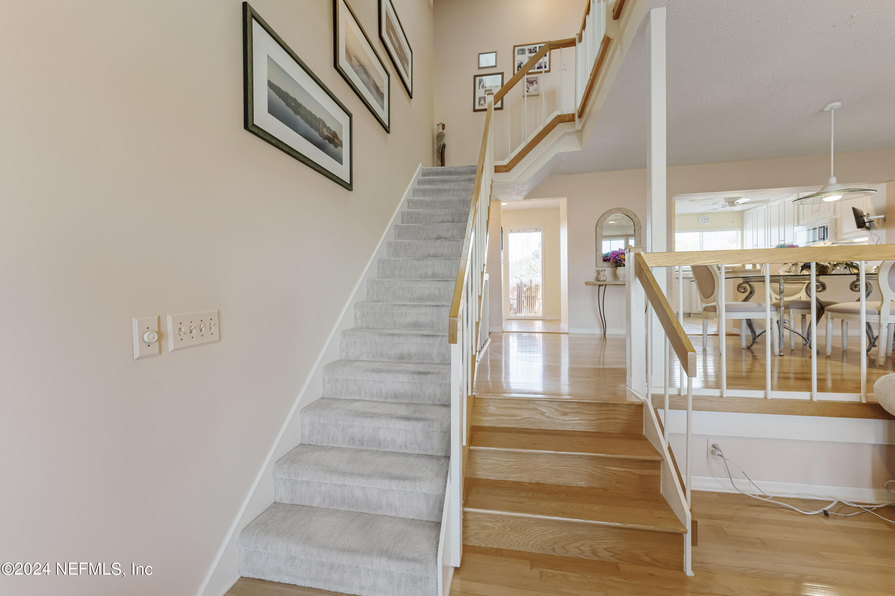 2279 Seminole Road, Unit 4 Atlantic Beach, FL 32233 - Photo 14 of 45 a view of staircase with lots of frames on wall and windows