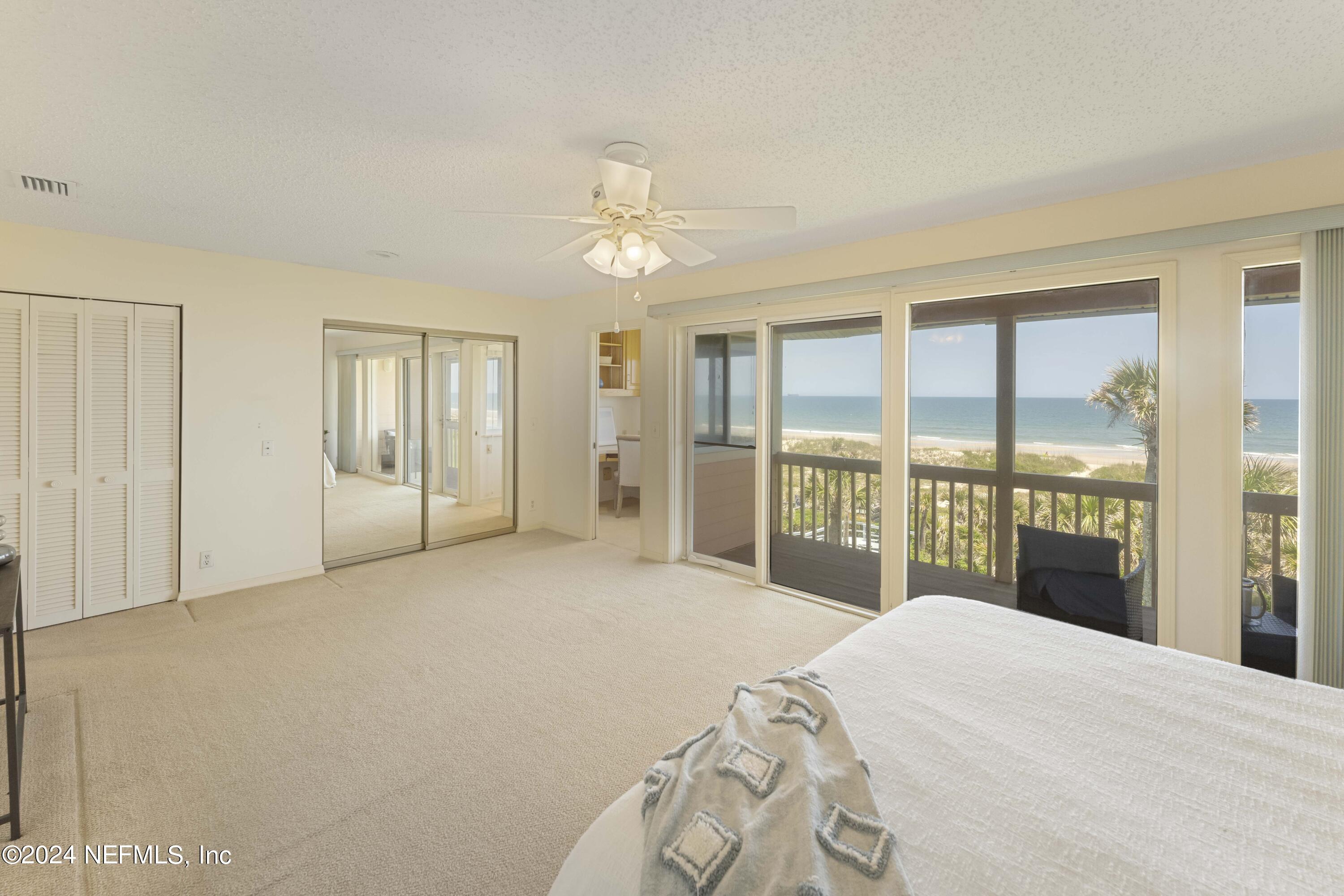 2279 Seminole Road, Unit 4 Atlantic Beach, FL 32233 - Photo 16 of 45 a bedroom with a large bed and a large window