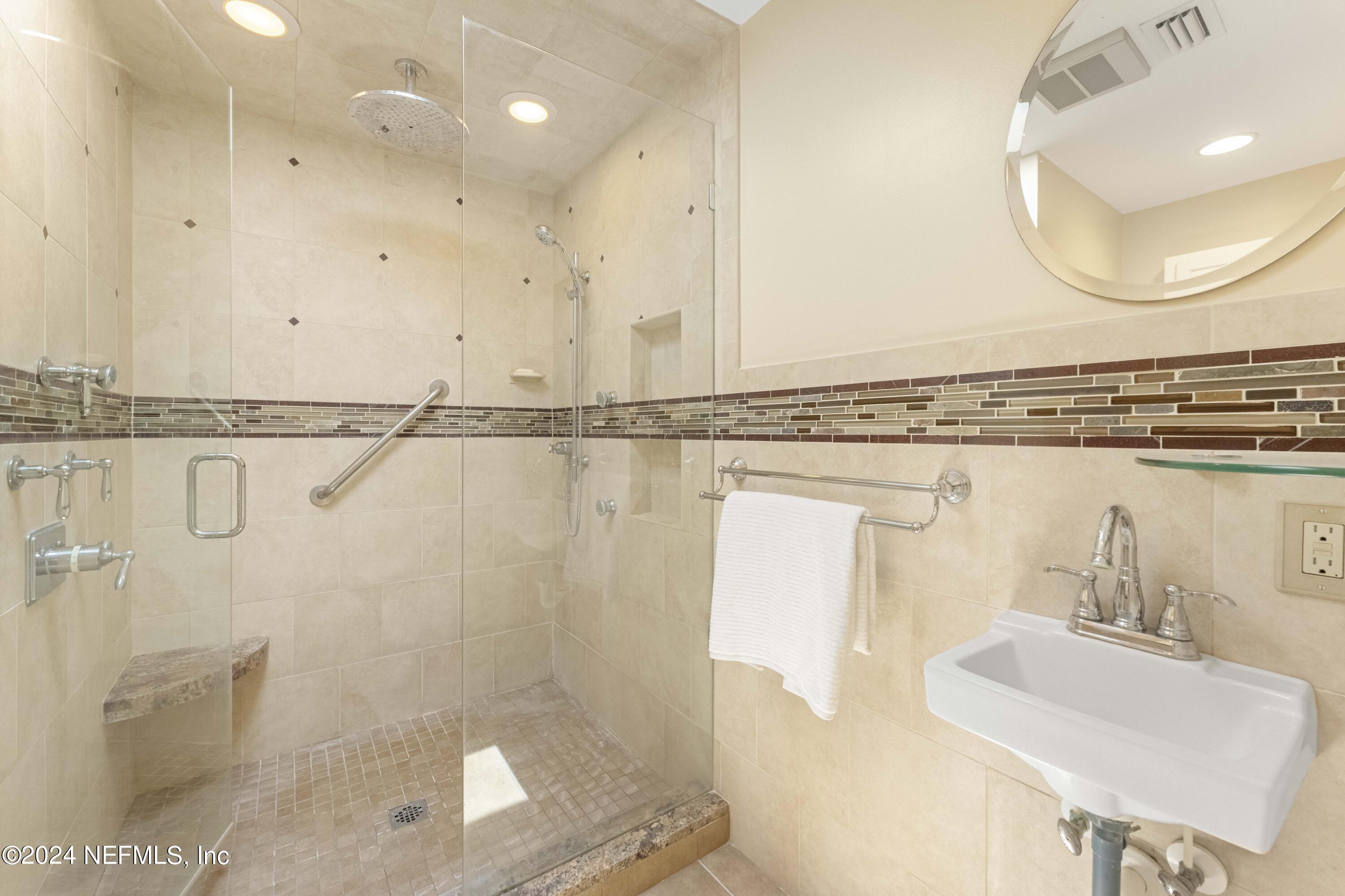 2279 Seminole Road, Unit 4 Atlantic Beach, FL 32233 - Photo 19 of 45 a bathroom with a sink mirror vanity and toilet