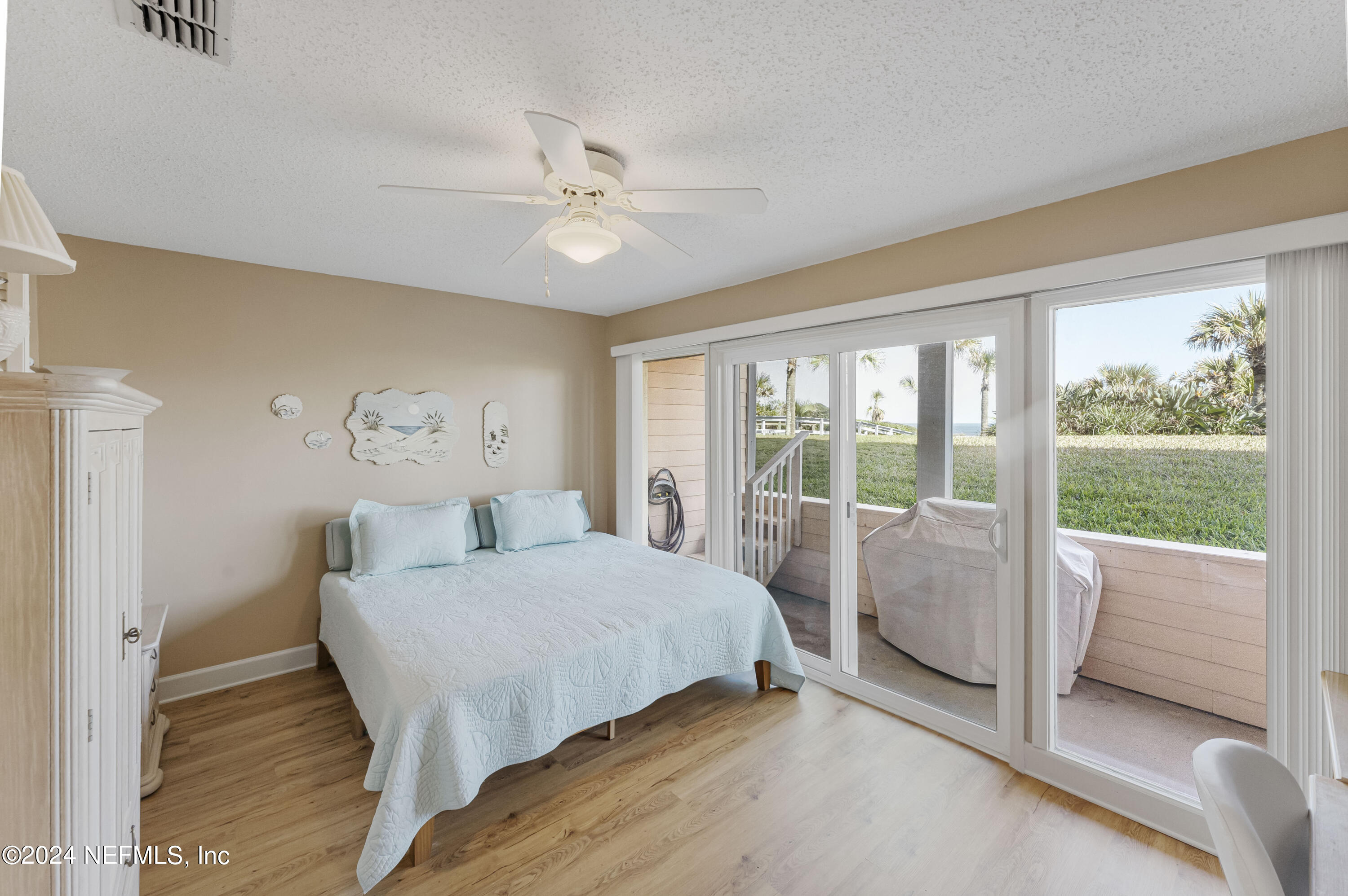 2279 Seminole Road, Unit 4 Atlantic Beach, FL 32233 - Photo 23 of 45 a bedroom with a bed and a large window
