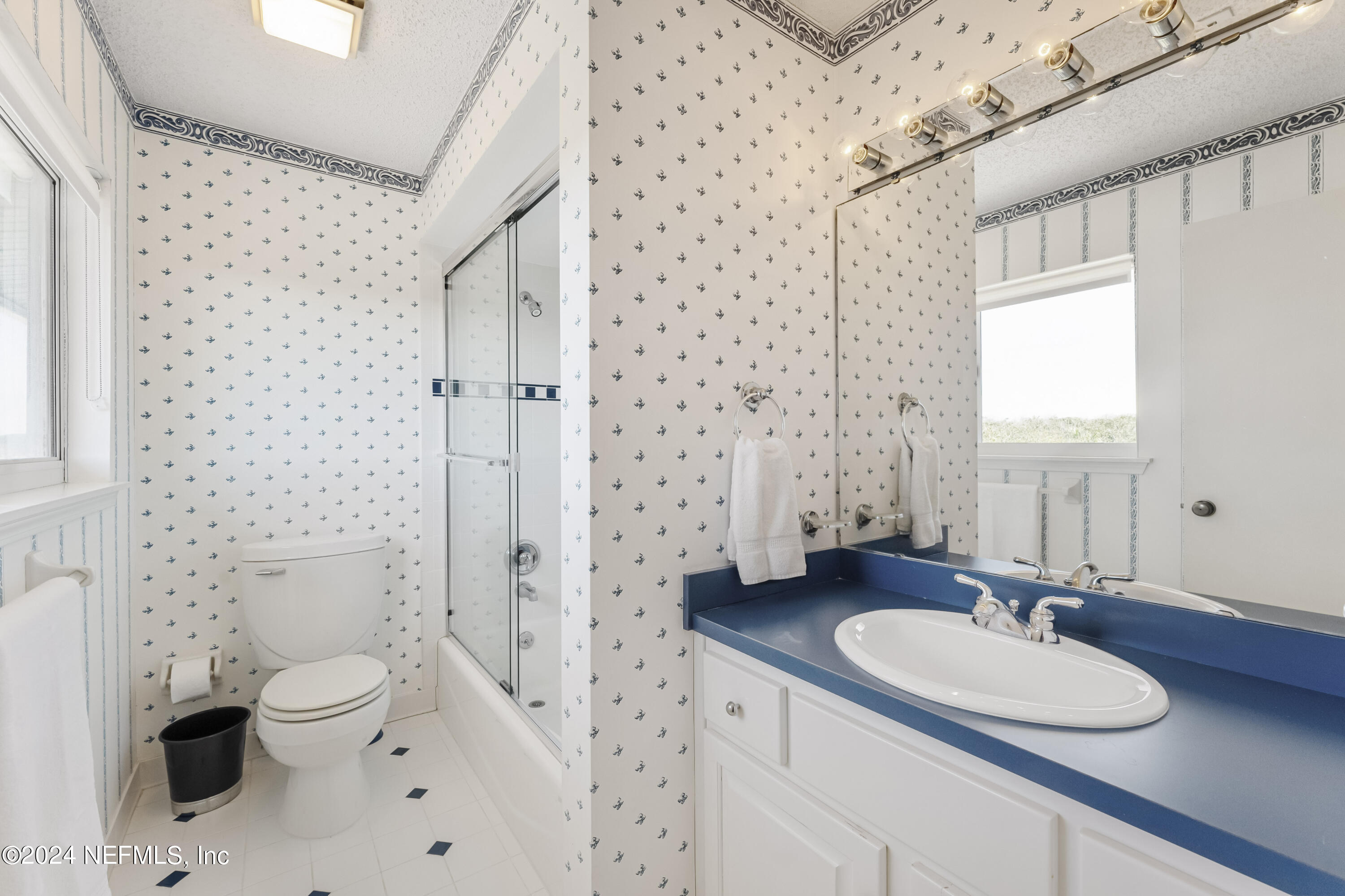 2279 Seminole Road, Unit 4 Atlantic Beach, FL 32233 - Photo 30 of 45 a bathroom with a sink toilet a mirror and shower