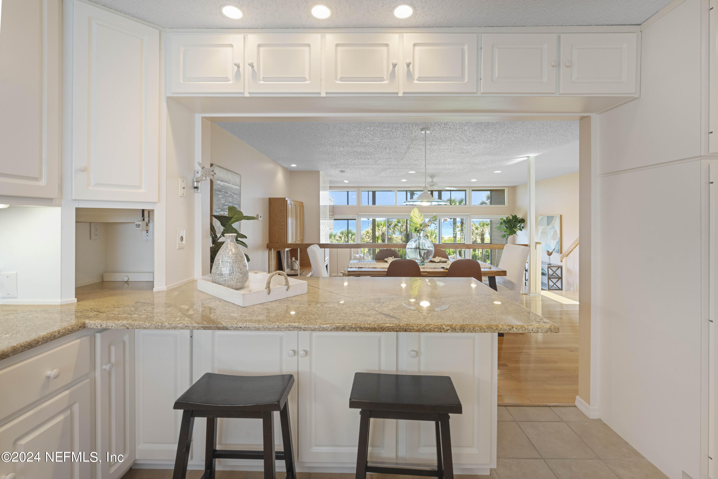 2279 Seminole Road, Unit 4 Atlantic Beach, FL 32233 - Photo 44 of 45 a kitchen with kitchen island granite countertop a counter top space appliances and cabinets