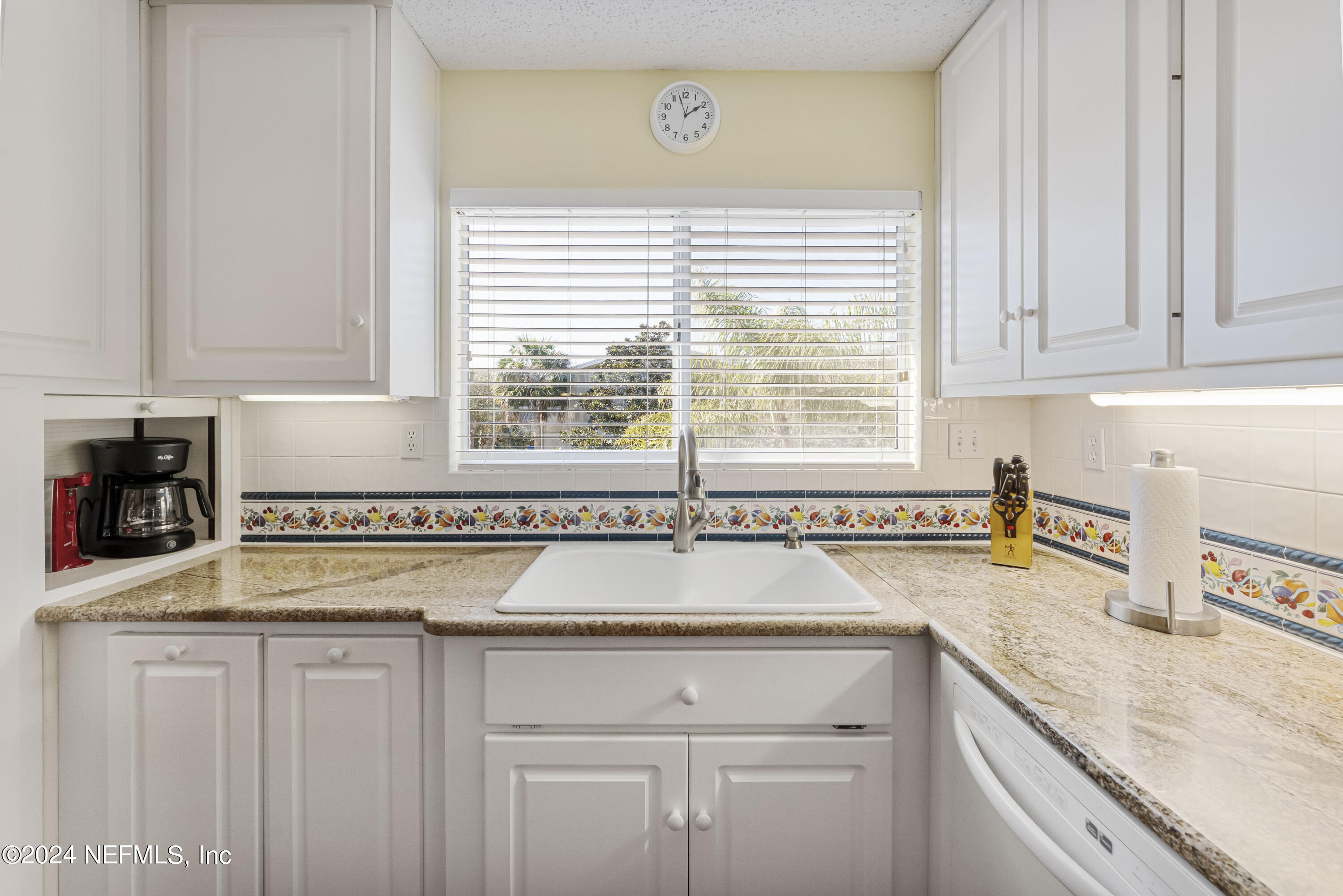 2279 Seminole Road, Unit 4 Atlantic Beach, FL 32233 - Photo 5 of 45 a kitchen with a sink cabinets and window