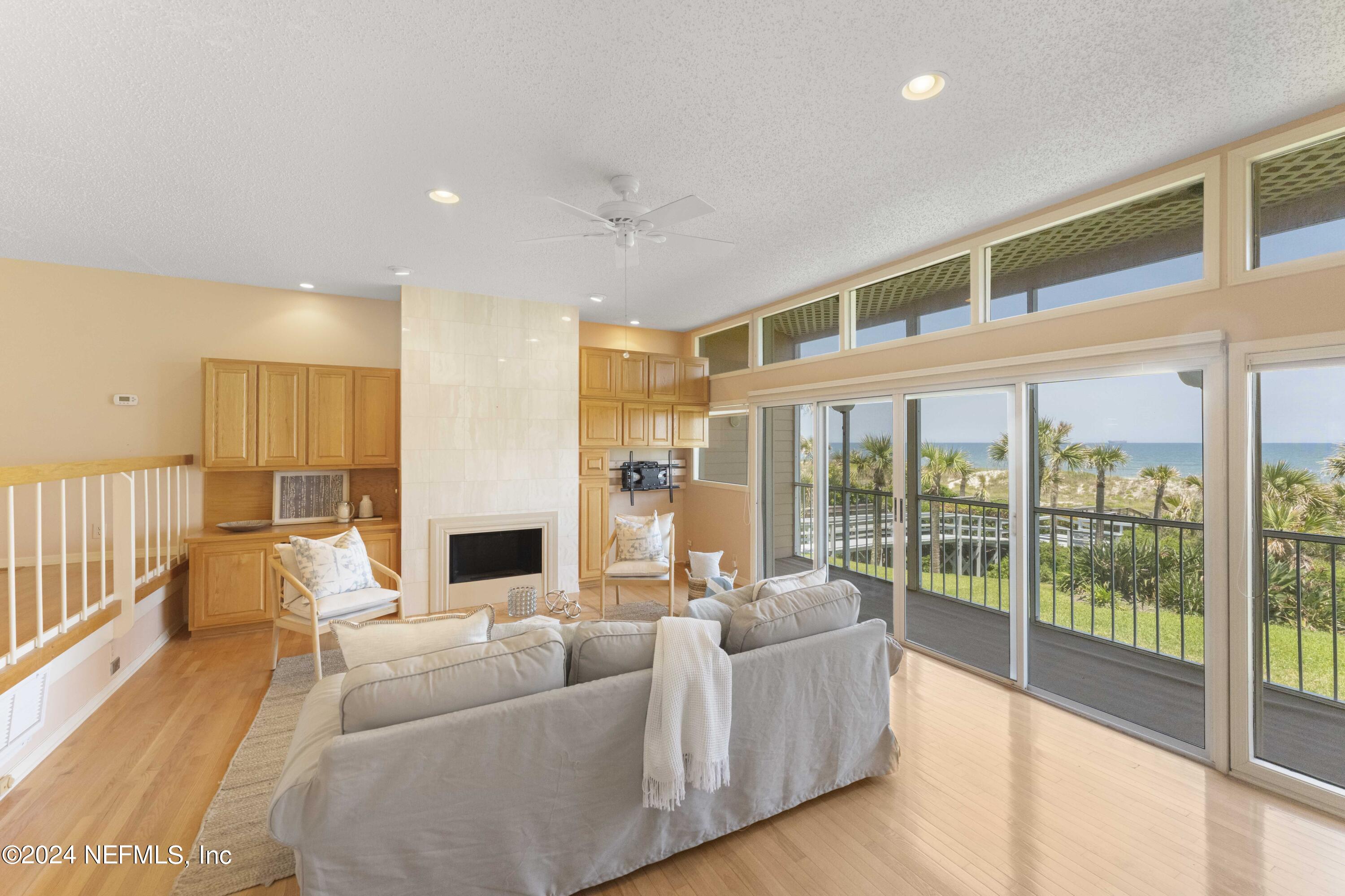 2279 Seminole Road, Unit 4 Atlantic Beach, FL 32233 - Photo 9 of 45 a living room with furniture fireplace and a large window