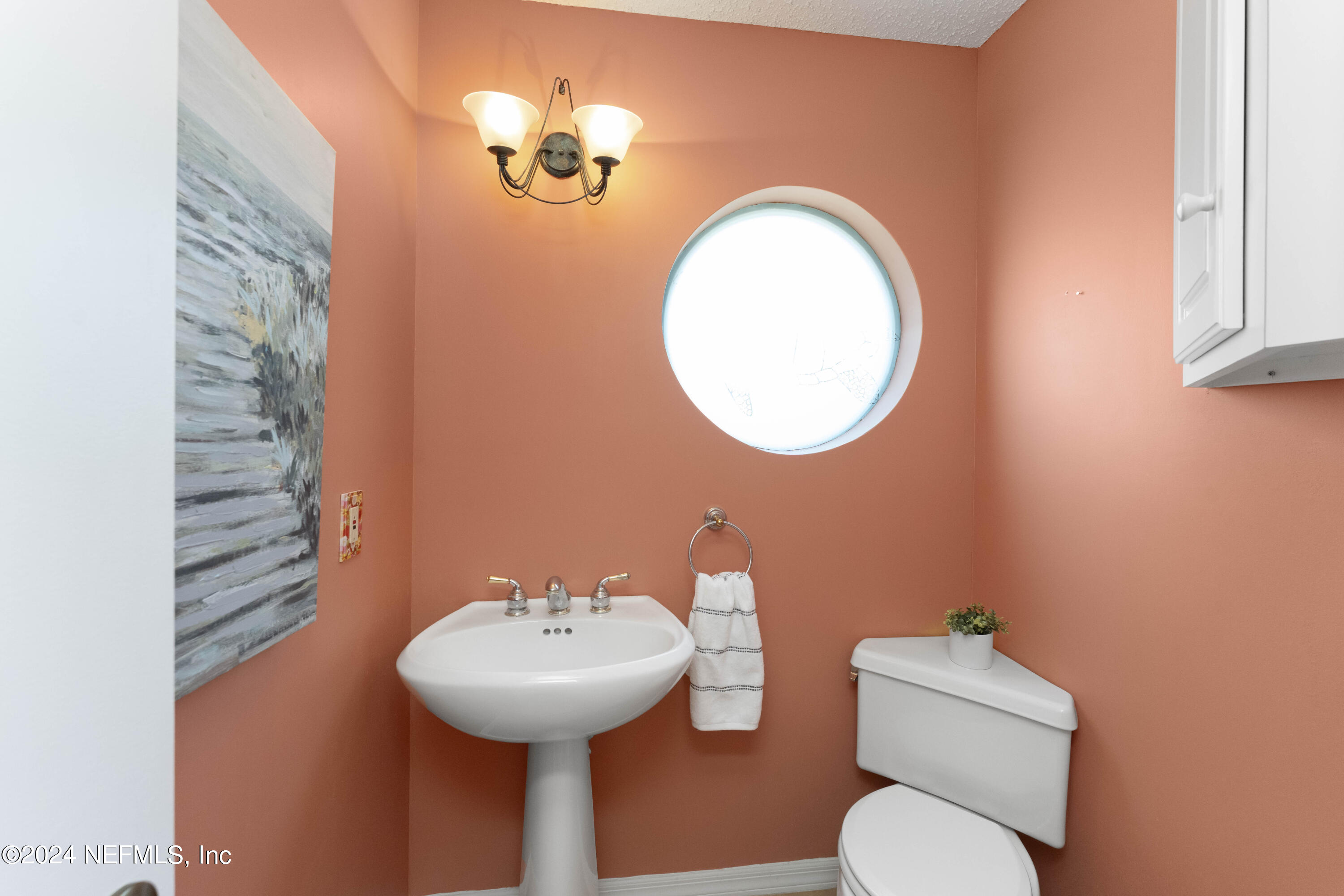 2279 Seminole Road, Unit 4 Atlantic Beach, FL 32233 - Photo 10 of 45 a bathroom with a toilet sink and mirror