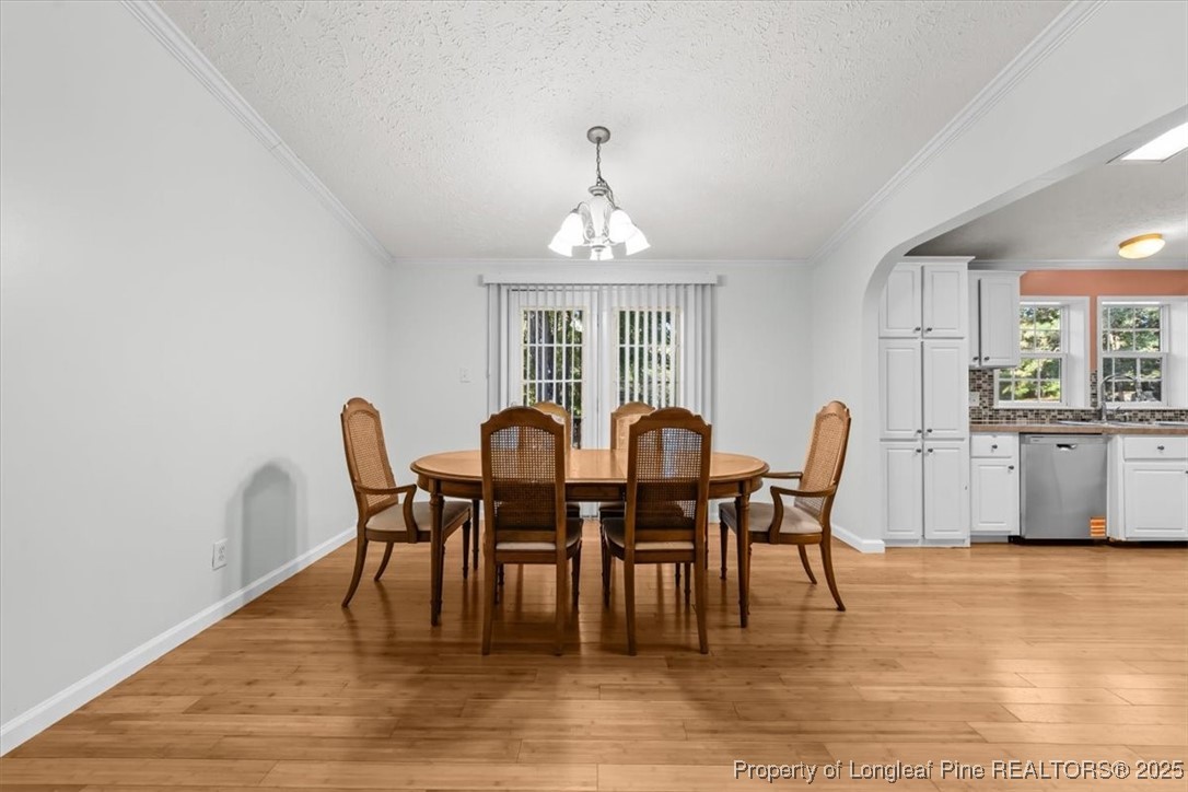 11891 Aberdeen Road Aberdeen, NC 28315 - Photo 5 of 35 a view of a dining room with furniture window and wooden floor