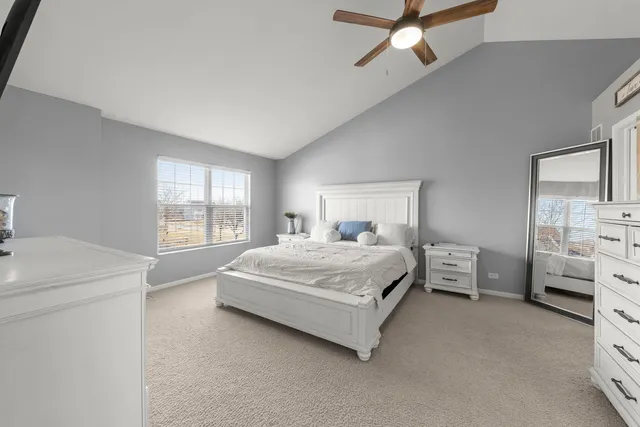 a spacious bedroom with a bed and a window