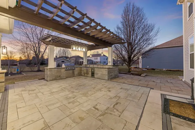 a view of a house with swimming pool and sitting area