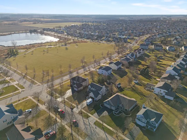 an aerial view of a house with a lake view