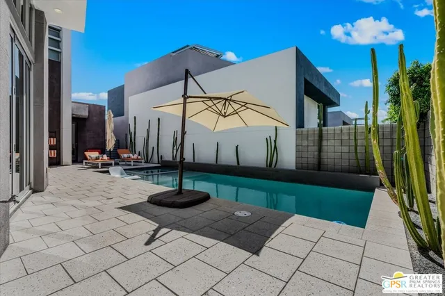 a view of a rooftop deck with couch and chairs