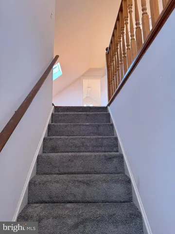 a view of a room with wooden floor and white walls