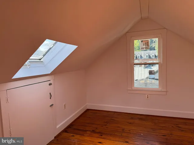 a view of a hallway view with wooden floor and staircase