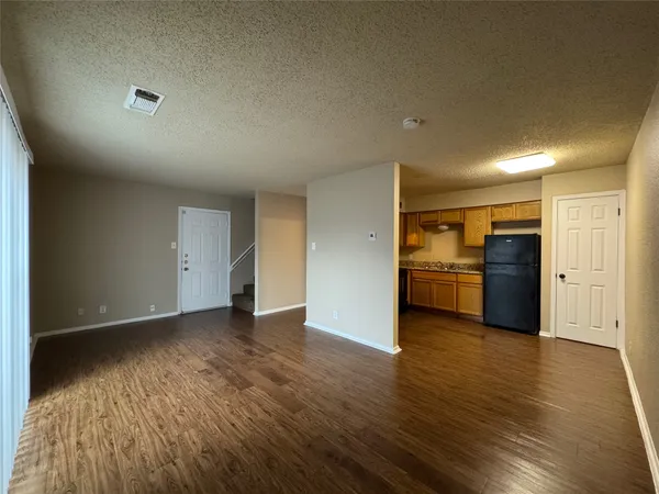 a view of a kitchen with a sink and a refrigerator