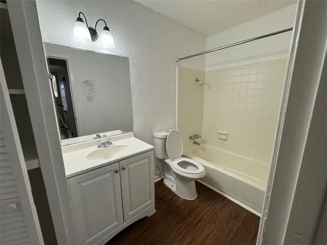 a bathroom with a sink toilet a mirror and shower