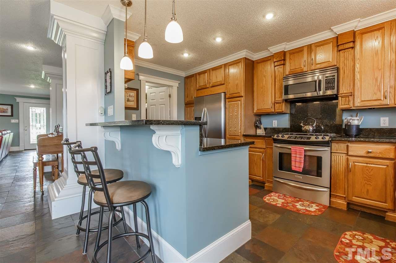 1117 Boone Road Burlington, NC 27217 - Photo 8 of 30 High bar seating, pendant lights and rich cabinetry