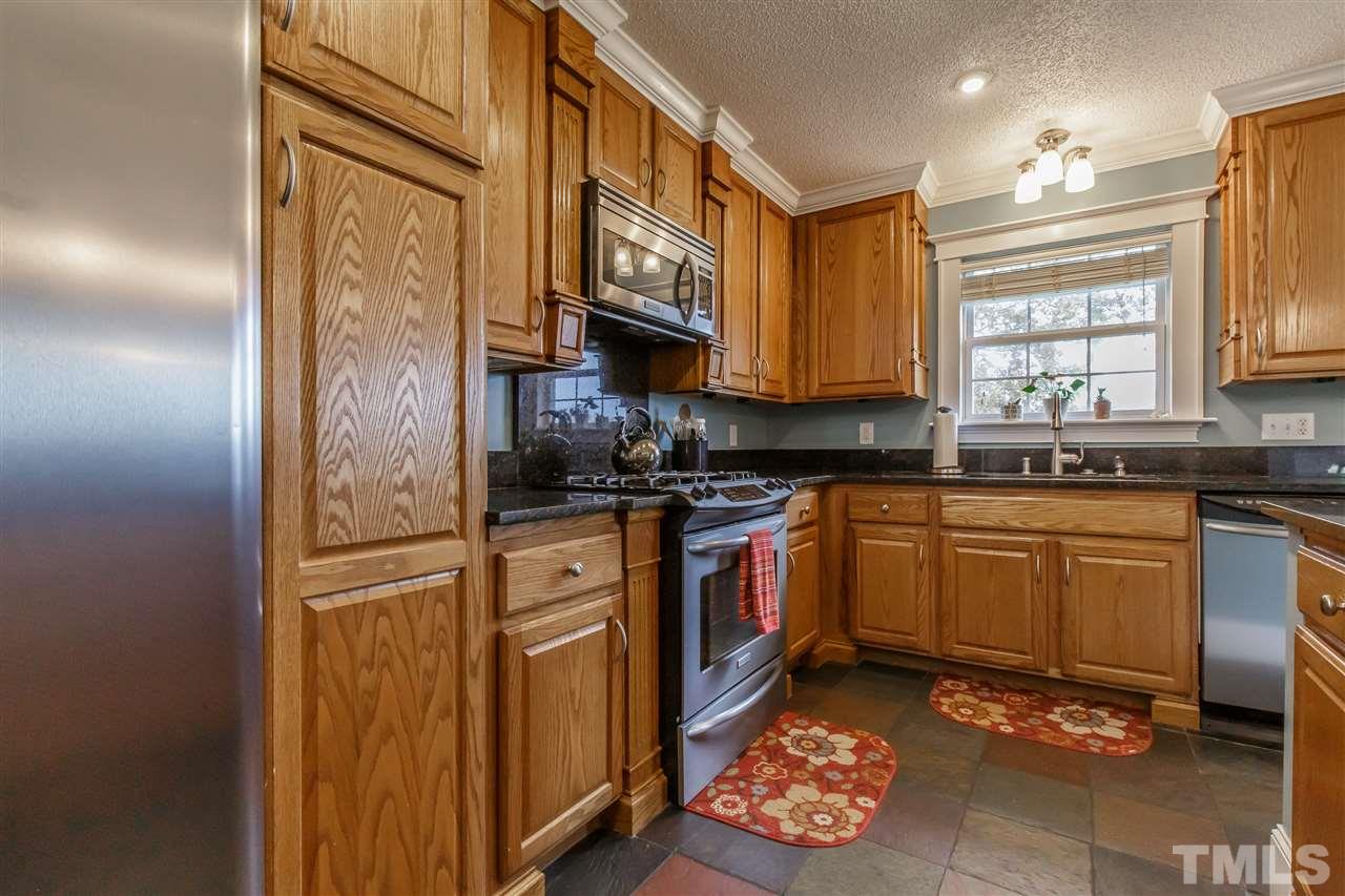 1117 Boone Road Burlington, NC 27217 - Photo 9 of 30 Stainless appliances include gas range, microwave, dishwasher and farmhouse stainless sink
