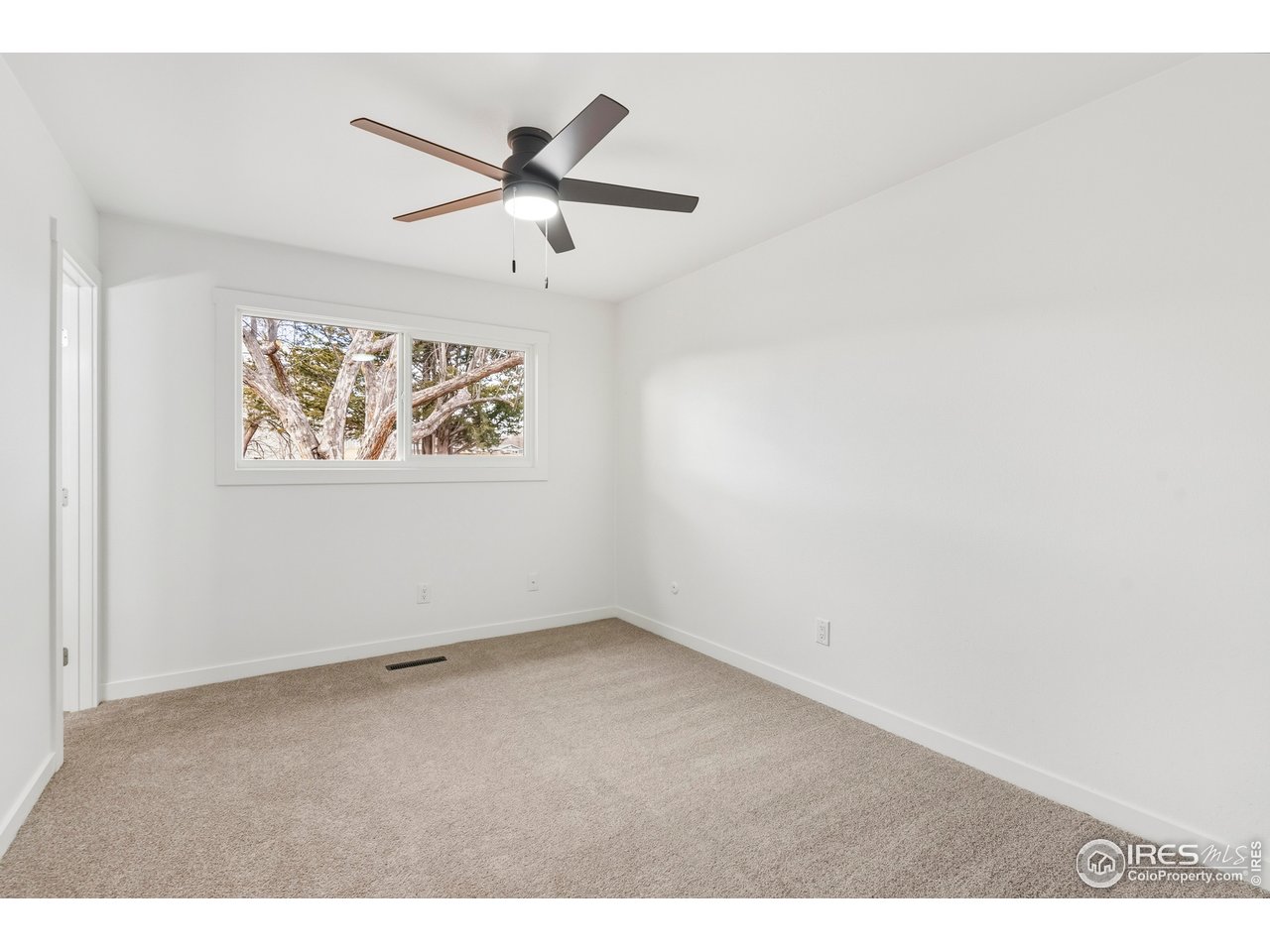 409 Franklin Street Fort Collins, CO 80521 - Photo 11 of 24 an empty room with a window and a ceiling fan