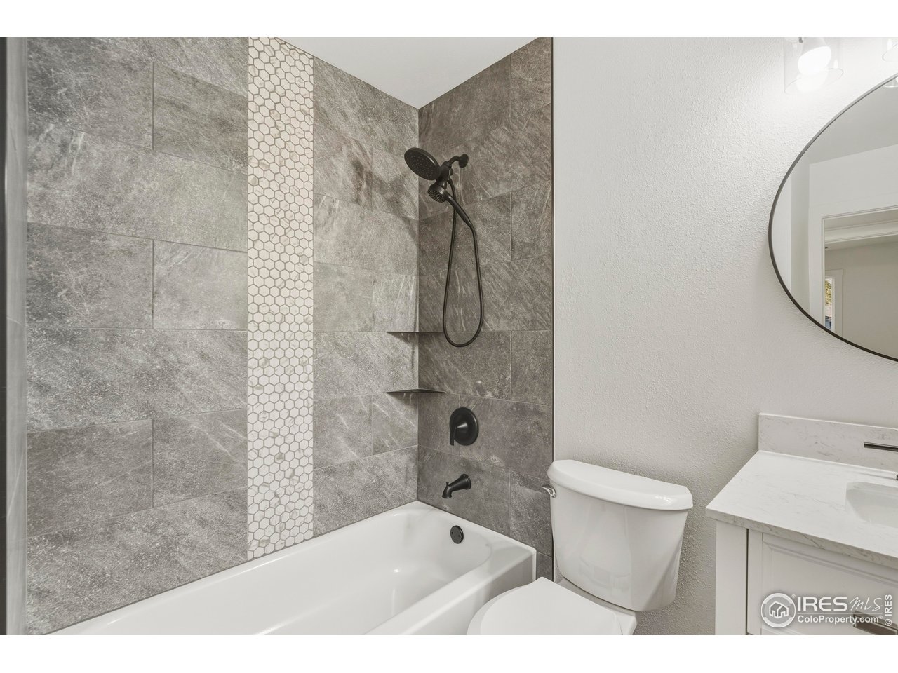 409 Franklin Street Fort Collins, CO 80521 - Photo 13 of 24 a bathroom with a granite countertop sink toilet and shower