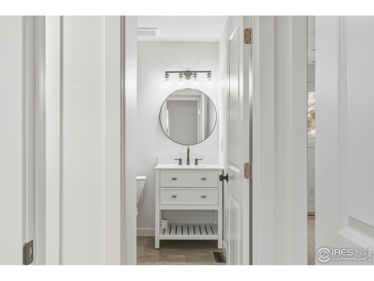 409 Franklin Street Fort Collins, CO 80521 - Photo 14 of 24 a bathroom with a sink a mirror and a toilet