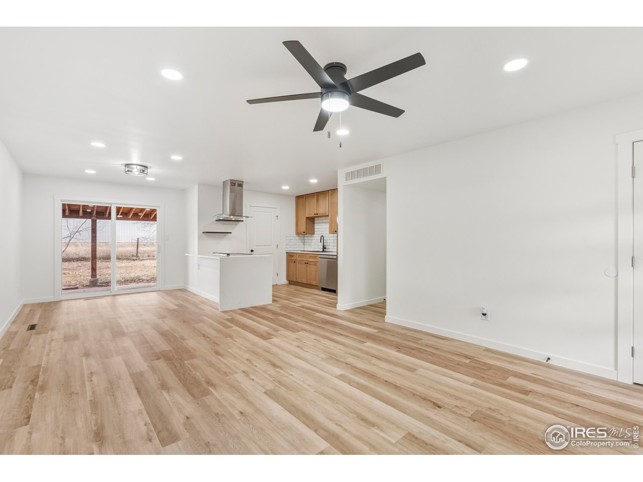 409 Franklin Street Fort Collins, CO 80521 - Photo 6 of 24 a view of empty room with wooden floor and ceiling fan