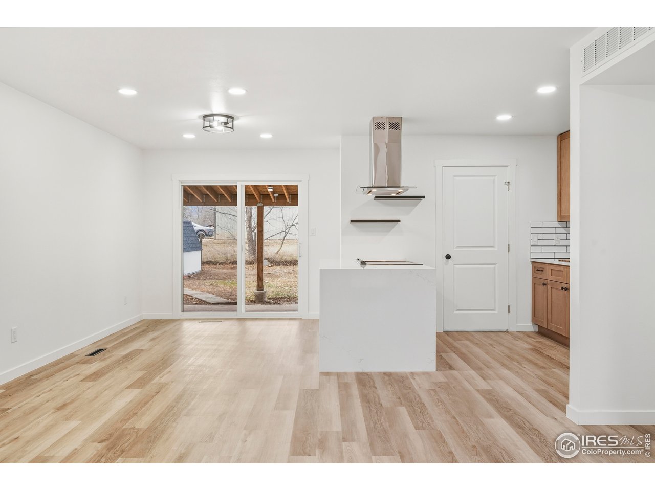 409 Franklin Street Fort Collins, CO 80521 - Photo 7 of 24 a view of empty room with wooden floor and fan