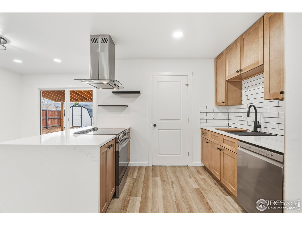 409 Franklin Street Fort Collins, CO 80521 - Photo 9 of 24 a kitchen with stainless steel appliances granite countertop a sink stove and refrigerator