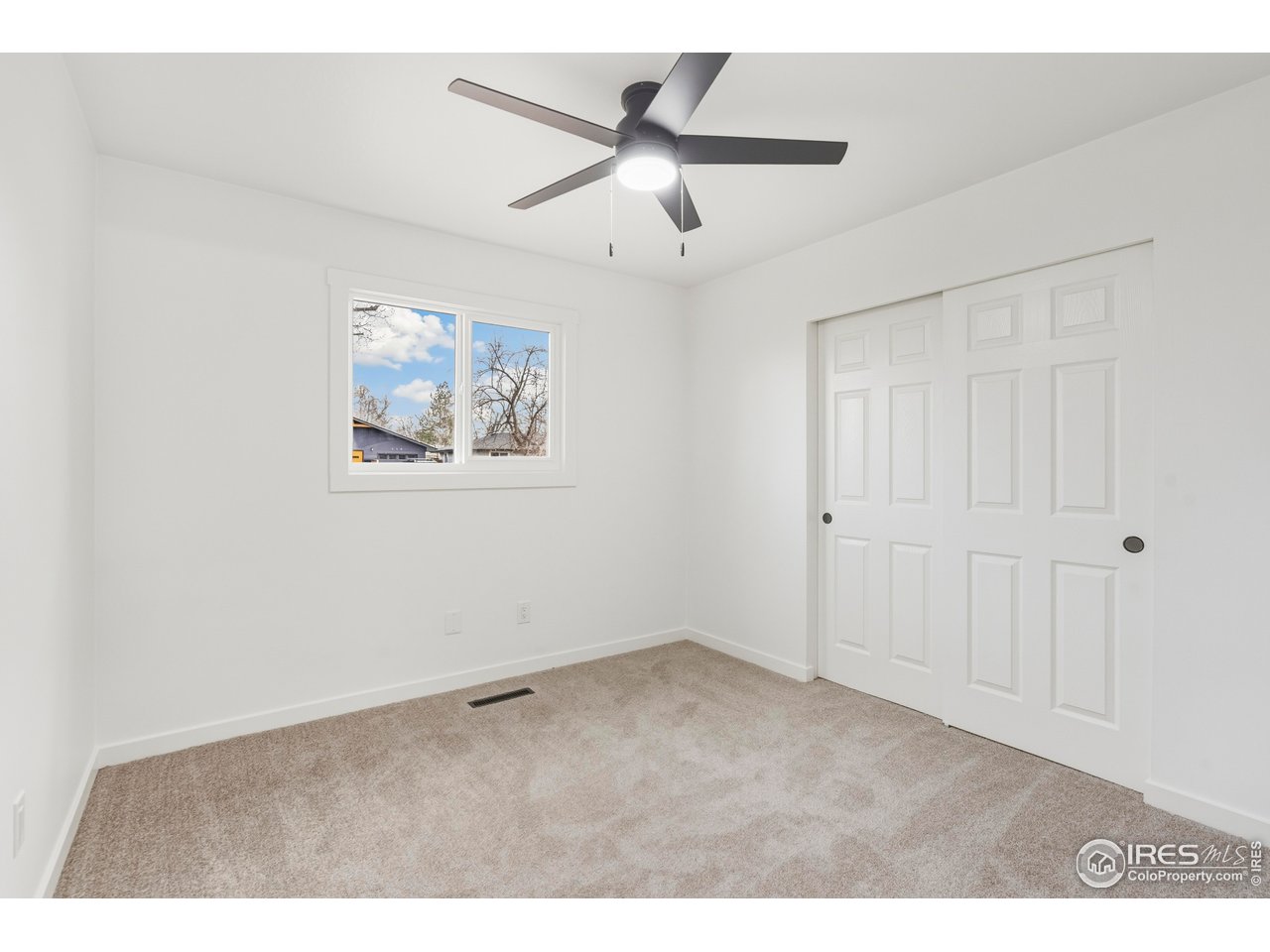 409 Franklin Street Fort Collins, CO 80521 - Photo 10 of 24 a view of an empty room with a ceiling fan