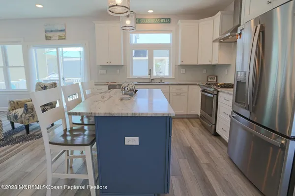 a kitchen with granite countertop a sink appliances a window and cabinets