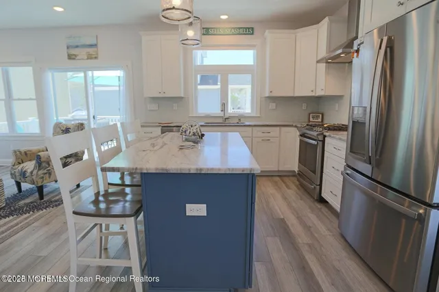 a kitchen with granite countertop a sink appliances a window and counter space