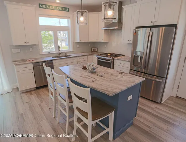 a view of a dining room with furniture wooden floor and a rug