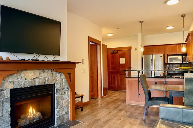 a living room with furniture a flat screen tv and a fireplace