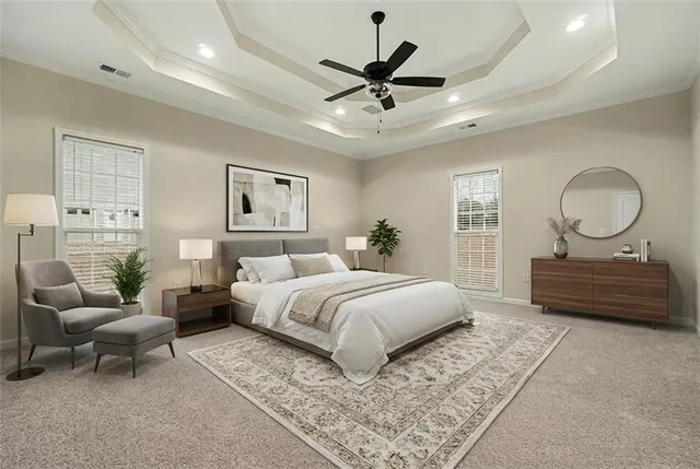 a spacious bedroom with a bed a couch and a chandelier
