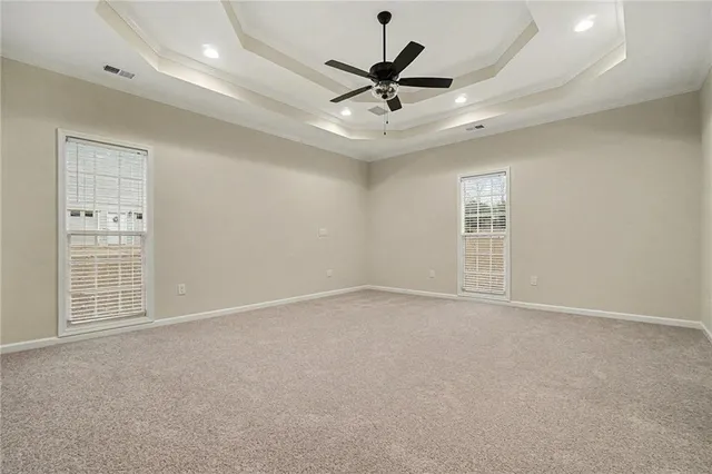 a view of an empty room with a ceiling fan