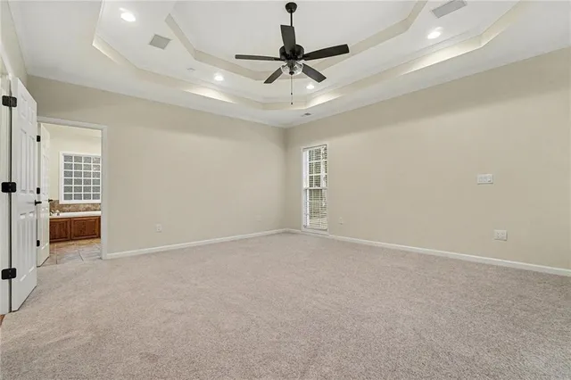 a view of an empty room with a ceiling fan