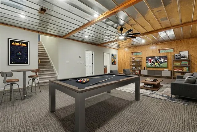 a room with furniture a flat screen tv and a table