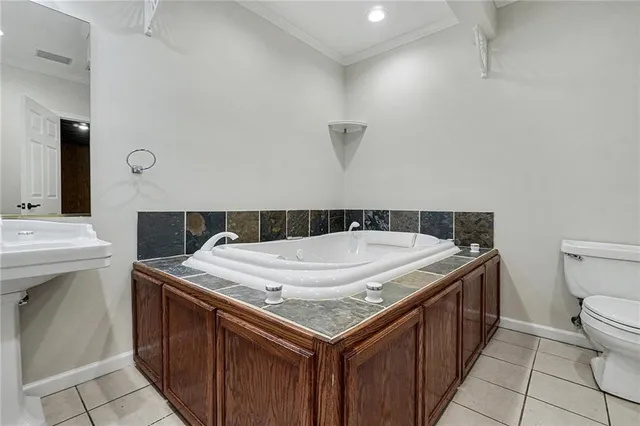a bathroom with a sink toilet and mirror