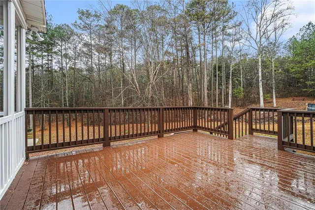 a view of a balcony with wooden floor and fence