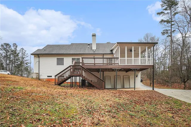 a view of a house with a yard and wooden fence