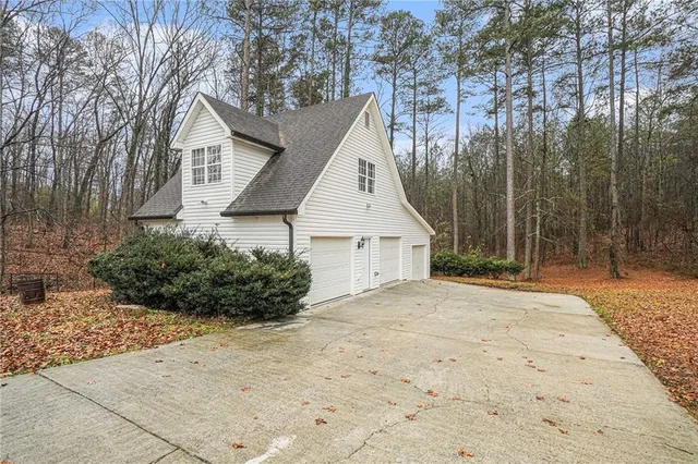 a view of a house with a yard and large tree