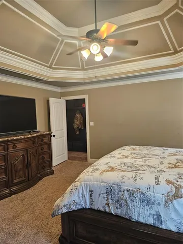 a spacious bedroom with a bed and a chandelier
