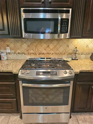 a refrigerator freezer sitting inside of a kitchen