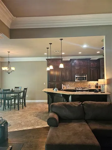 a bathroom with a granite countertop toilet sink and mirror