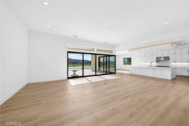 a large white kitchen with stainless steel appliances