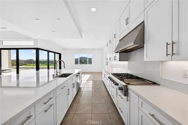 a kitchen with stainless steel appliances a stove a microwave and cabinets